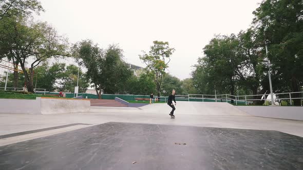 Skateboarder in Skate Park Doing Tricks Slow Motion