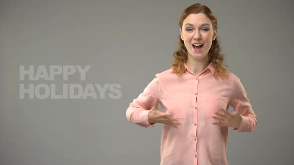 Lady Saying Happy Holidays in Sign Language, Text on Background, Communication
