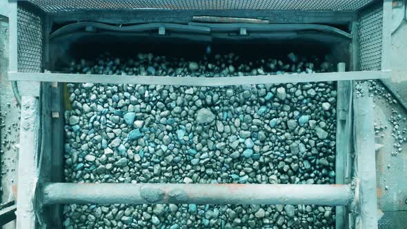 Top View of Crushed Minerals Falling From the Conveyor Belt