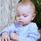 Baby Taps Her Hand on Developing Cube Then Looks at Camera and Smiles Sweetly - VideoHive Item for Sale