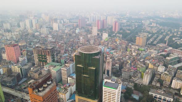 Aerial Circle Dolly Over Hazy Morning Cityscape In Asia, City Centre