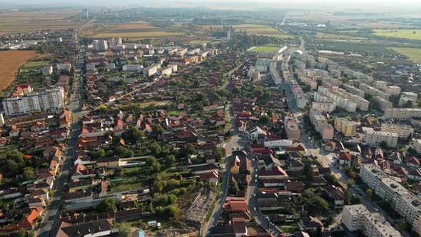 Aerial drone view of the Fagaras, Romania. Multiple residential buildings, roads with cars