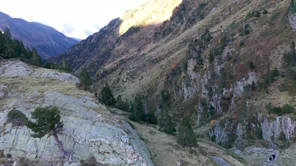 Hikers at Val d'Arrouge creek canyon leading to Lac d'Espingo mountain lake in Haute-Garonne, Pyréné