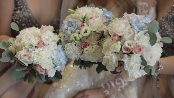 Faceless Bride and Two Bridesmaids Posing with Bouquets. Wedding