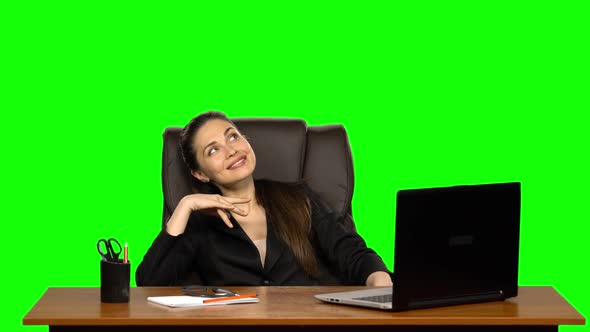 Business Woman in the Workplace Dreams of Something, Smiles with Pleasure. Green Screen. Studio