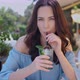 Beauiful Woman Sitting in Outdoor Restaurant and Sip Mojito Dring in Summer Hot Day - VideoHive Item for Sale