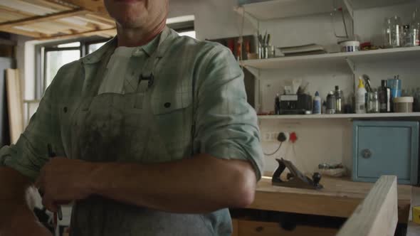 Portrait of a man in his workshop at home