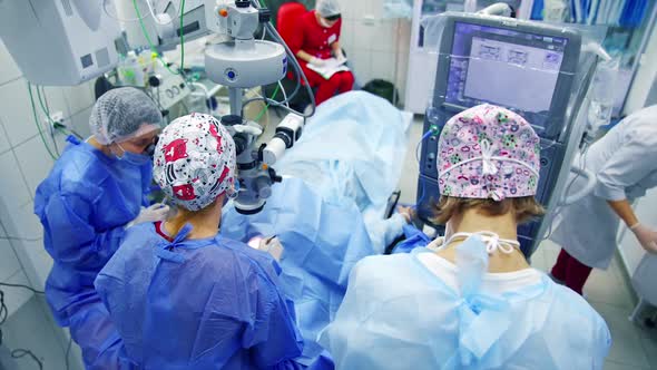 Close up of surgery team operating. Surgeons operating eye of patient at the operating room