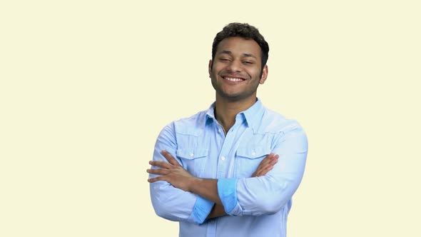 Young Smiling Man Crossed Arms on White Background.