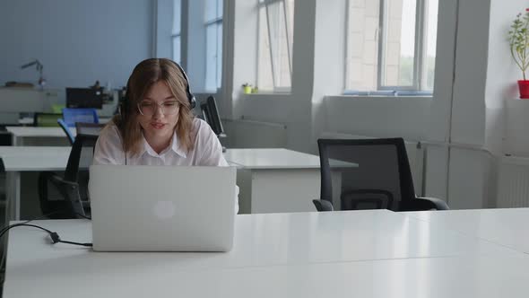 Office Worker in Black Headphones Makes Video Call