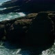 The Sea Foams Near the Coastal Cliffs on a Sunny Day - VideoHive Item for Sale