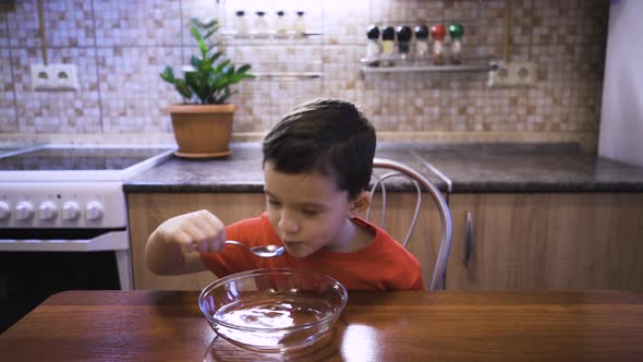 A Boy Eats Tasteless Soup From Water Because He Does Not Feel the Taste