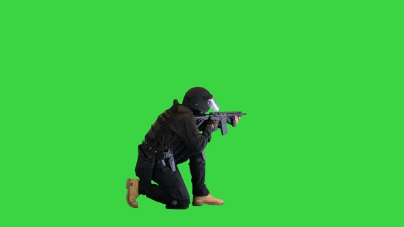 Antiterrorist Unit Shooting From Sitting Position on a Green Screen Chroma Key