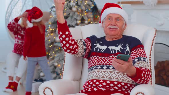 Senior Old Grandfather Man Buy Christmas Gift Presents Doing Online Shopping on Mobile Phone at Home