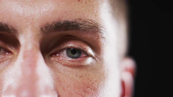 Close up portrait of face of caucasian man with focus on blinking eye