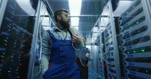 Two Men Performing Maintenance in a Data Center