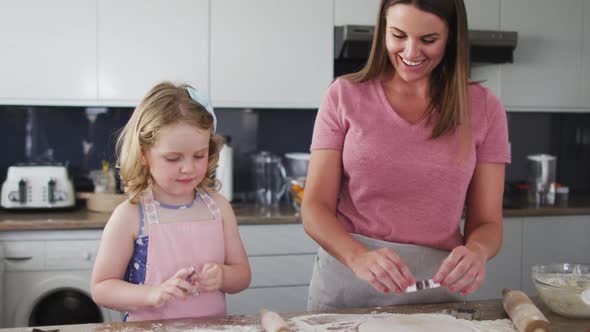 Caucasian mother and daughter having fun cooking together