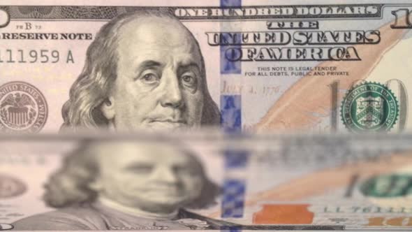 One Hundred Dollar Bills in a Bill Counter