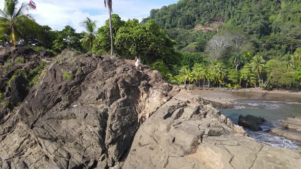 Aerial view of young woman climbing and hiking on a mountain in Costa Rica