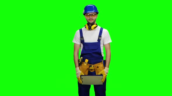 Engineer Picks Up the Paper Plate and Smiles, Green Screen