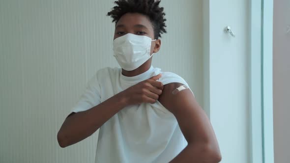 African American Teenager Showing COVID19 Vaccine Bandage Merrily