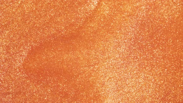 Colorful Golden Sand Organically Moves in Colorful Liquid in Macro alt