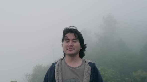 Male traveller enjoying the view at the top of mountain.