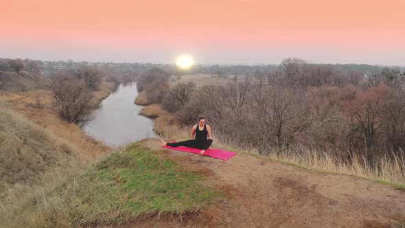 Young Woman Doing Yoga in Quiet Scenery