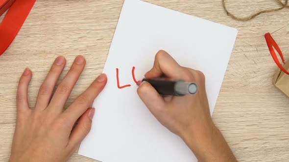 Woman Writing Love Word on Paper, Romantic Relationship Between Man and Woman