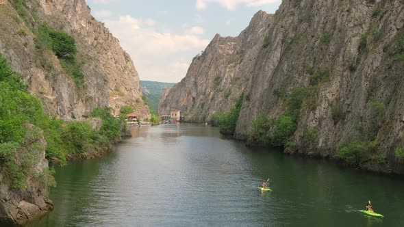 Unidentified Tourists Kayaking on the Lake Matka in Rocky Canyon