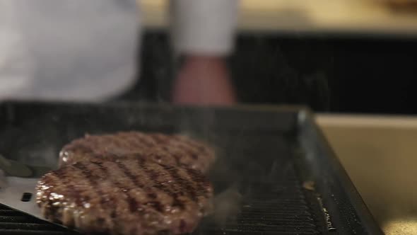 Cooking beef and pork patty burger. Meat beef patty is cooked on hot grill pan