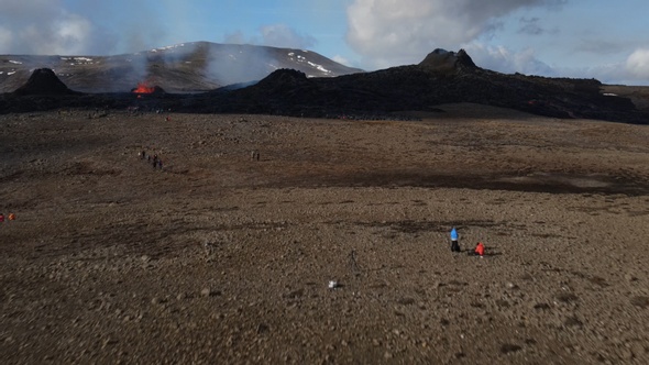 People visiting active volcano aerial view, Mount Fagradalsfjall, Iceland