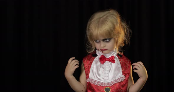 Dracula Child. Girl with Halloween Make-up. Vampire Kid with Blood on Her Face