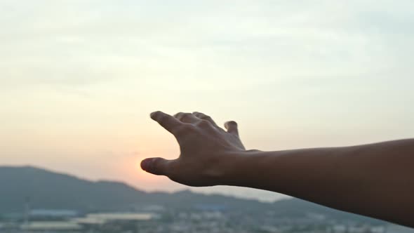 Hand touch the sunset 