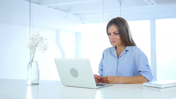 VIdeo Chat on Laptop by Woman Sitting in Office for Work