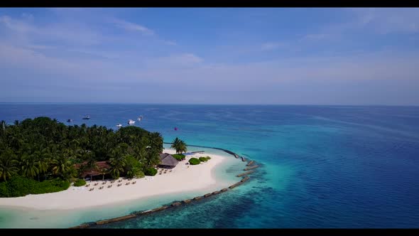 Aerial above scenery of relaxing shore beach trip by shallow lagoon with white sandy background of a