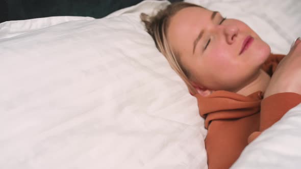 Close Up Portrait of Relaxed Woman Sleeping on a White Pillow in Bed