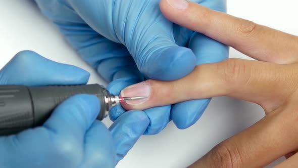 Master of Manicure Treats the Cuticles with a Special Device. Close Up