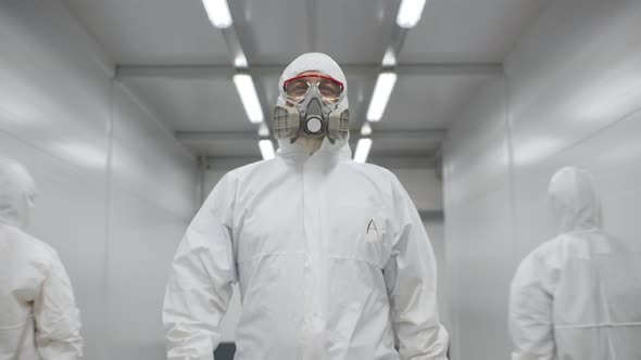 Doctor in Protective Wear Walking Along Hospital Hall