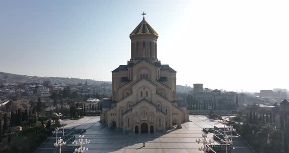 Aerial view of Holy Trinity Cathedral Sameba in Tbilisi Georgia. Sunrise drone footage.