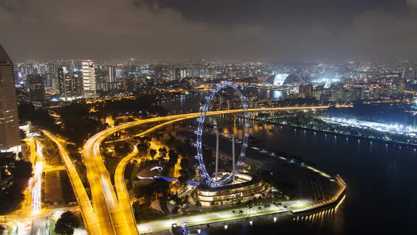 Road Highway To the Night Cityscape Skyline at Singapore with Ferris Wheel