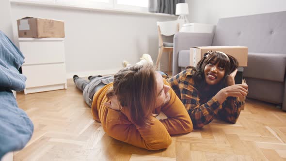 Young Happy Couple Relaxing on the Floor of the New Appartment