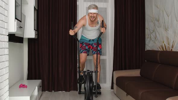 Funny Athlete Sportsman Guy Trainer on Orbitrek Recording Sport Fitness Cardio Online Vlog at Home