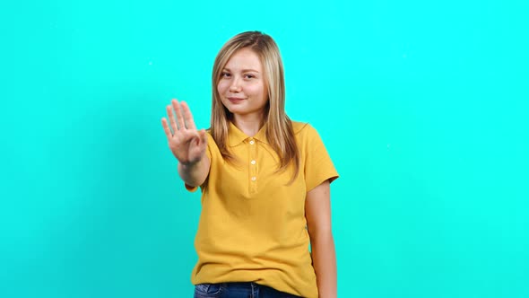 The Modest Young Woman Puts Her Palm in Front of Her and Says Stop.