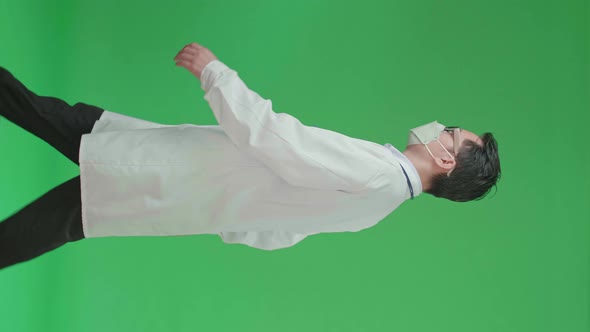 The Side View Of Asian Doctor With Stethoscope Wearing Mask While Walking On Green Screen