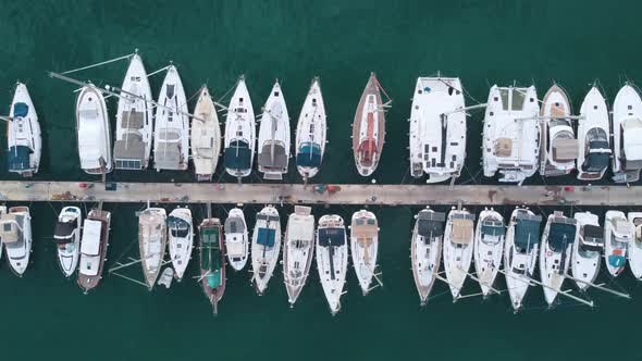 Aerial top view of marina with moored yachts and boats.