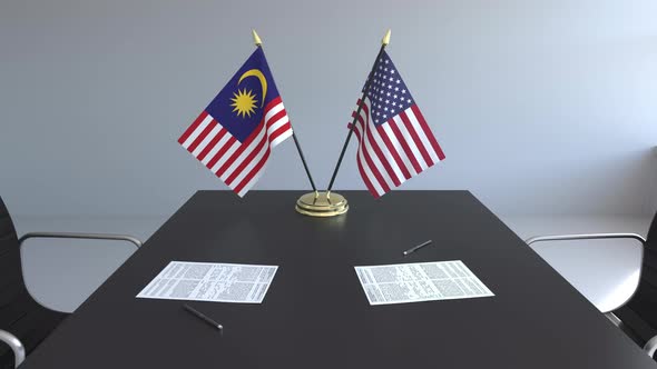 Flags of Malaysia and the United States on the Table