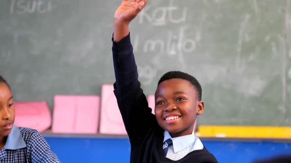 Schoolkid hand raised in the classroom 4k