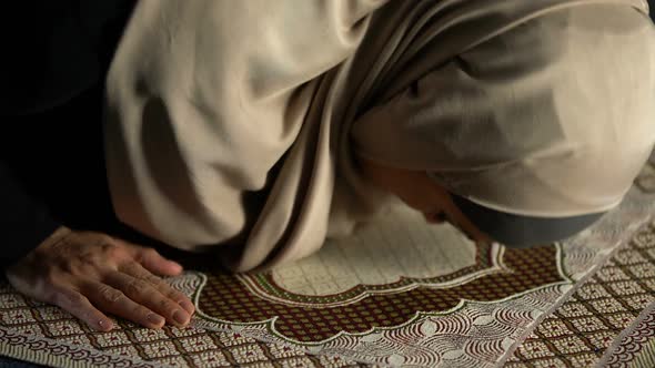 Woman in Hijab Prostrating on Prayer Rug, Obligatory Religious Ritual, Worship