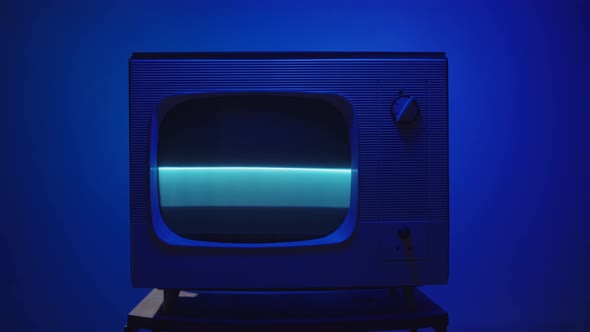 Old Vintage Television on Blue Neon Background Closeup